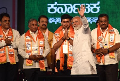 Prime Minister Narendra Modi waves to supporters at a Bharatiya Janata Party election rally in Bangalore on April 13, 2019. EPA