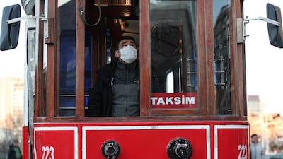 A driver wearing a protective mask drives a tram along Istiklal street, the main shopping street in Istanbul, amid the coronavirus outbreak, in Turkey. AP Photo