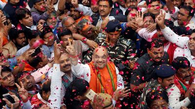 Amit Shah, centre, the president of India’s ruling Bharatiya Janata Party, celebrates with party supporters after learning of the initial poll results inside the party headquarters in New Delhi, India on March 11, 2017. Adnan Abidi / Reuters