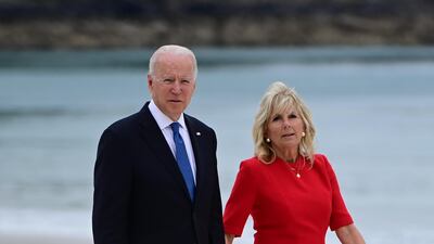 President Joe Biden and Jill Biden, in a red dress and shoes, arrive at the leaders' welcome during the G7 Summit in Cornwall on June 11, 2021. EPA
