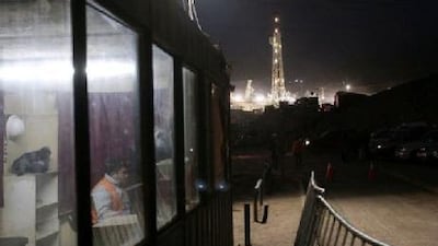 A guard watches the entrance to the area where three rigs are drilling down to the San Jose mine tunnel to rescue the 33 trapped miners. Luis Hidalgo / Reuters