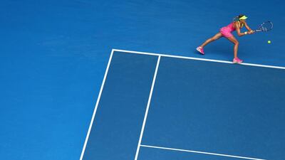 Eugenie Bouchard returns a shot on Tuesday to Maria Sharapova during their Australian Open quarter-finals match. Cameron Spencer / Getty Images