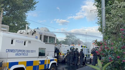 Police fire water cannon at protesters near the Sandyknowes roundabout. PA