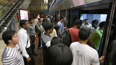 Passengers trying to board the Dubai Metro without letting others get off is part of the culture gap still in place after five years. Photo: Pawan Singh / The National