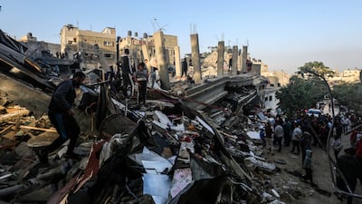 People search through the rubble of buildings destroyed during Israeli air raids in the southern Gaza Strip. Getty Images