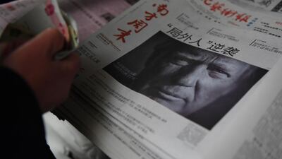 A man buys a Chinese newspaper, with the headline that reads “Outsider strikes back”, featuring Donald Trump on the front page in Beijing. Greg Baker / AFP