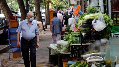 An Iranian man looks at items for sale at a shop in Tehran. The government has sharply increased the price of basic food items such as cooking oil, chicken, eggs and dairy products. EPA