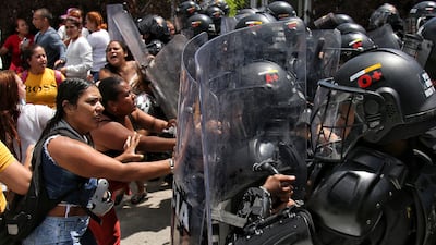 Inmates' relatives push back at police riot shields outside a prison in Tulua, Colombia, where a fire killed at least 51 people in what authorities said was an attempted riot on Tuesday. AP