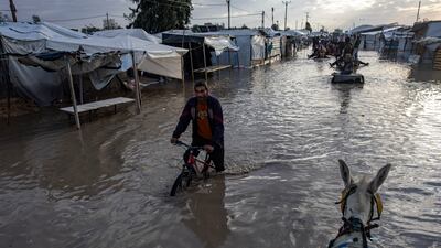 Flooding after heavy rain in Khan Younis, southern Gaza. In addition, an eight-month-old baby girl died on December 11 due to extreme cold in the city. EPA