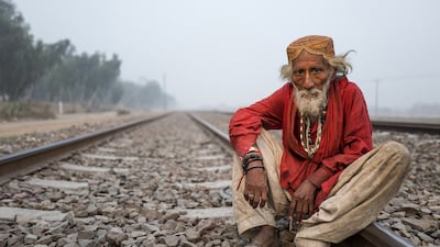 Photograph of a Sufi mystic sitting on a railway track in Sahiwal, Pakistan, by Sohail Karmani. Courtesy Sohail Karmani