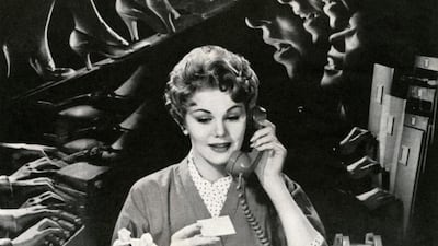 Woman On Phone In Noisy Office. Getty Images