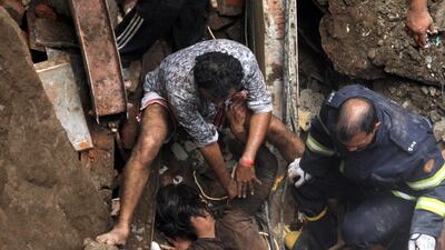 Rescue workers pull out a victim from the rubble. Reuters