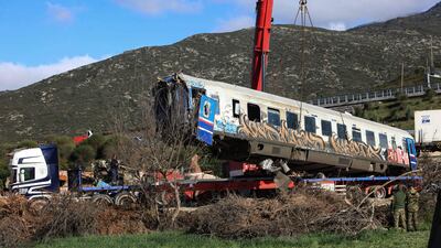 A damaged carriage is removed from the scene after a head-on collision between two trains near Larissa, Greece, on February 28. AFP