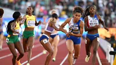 Sydney McLaughlin receives the baton from Britton Wilson in the women's 4x400m relay final. AFP