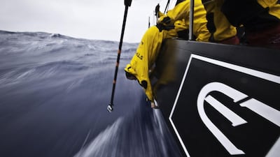 Craig Satterthwaite of New Zealand hangs over the side of Azzam to tighten up bolts in the damaged hull area, whilst being filmed by a GoPro camera on a pole, during Leg 5 of the 2011/12 Volvo Ocean Race, from Auckland, New Zealand to Itajai, Brazil, on April 2, 2012. Nick Dana / Abu Dhabi Ocean Racing