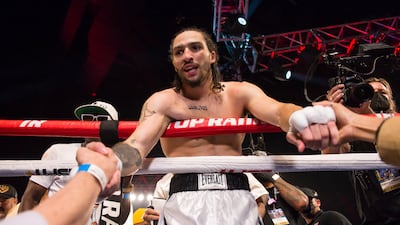 Nico Ali Walsh holds hands with his mother, Rasheda Ali Walsh, right, and father, Bob Walsh, after defeating Jordan Weeks in their middleweight bout.
