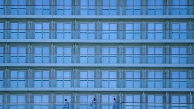 This picture taken on March 23, 2020 shows Norwegian Cruise Line employees cleaning a cruise ship in Miami, amid fears over the spread of the COVID-19 novel coronavirus. / AFP / Chandan KHANNA