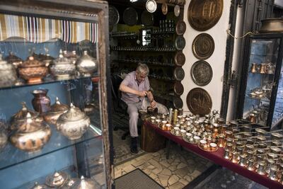 A craftsman makes a traditional Turkish coffeepot inside his souvenir store in the Bascarsija bazaar, in Sarajevo Bloomberg