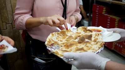 A foodie tastes Egyptian pizza on the Middle Eastern Food Pilgrimage tour. Courtesy: Frying Pan Adventures