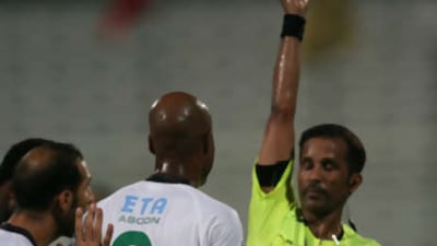 Al Shabab's Marcos Assuncao is shown a red card.