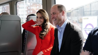 The prince and princess smile on the Elizabeth Line. PA
