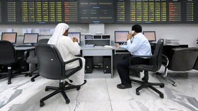 Traders work at the Bahrain stock exchange in Manama, which is considering merging with another bourse. Phil Weymouth / Bloomberg News