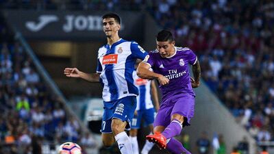 James Rodriguez of Real Madrid scores his team’s first goal under a challenge by Gerard Moreno of Espanyol. David Ramos / Getty Images