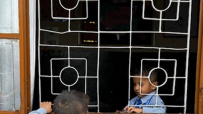 Two boys enjoy break time at the school, which caters for children from nursery age to 10th grade