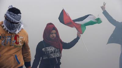 A protesters waves a Palestinian flag near the US embassy in Awkar, Lebanon on December 10, 2017. Lebanon hosts hundreds of thousands of Palestinian refugees, including those who fled or were expelled from their homes after the creation of Israel. Mohamed Azakir / Reuters