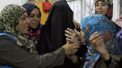Heba Fayyad arrives for her henna party at the United Nations Beit Lahiya Preparatory School for Girls, which has become a shelter for Gazans dispaced by Israeli attacks, on August 12,2014. Heidi Levine for The National
