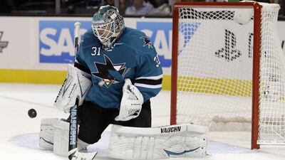 San Jose Sharks goalie Antti Niemi, of Finland, stops a shot by the Vancouver Canucks during the second period of a National Hockey League hockey game on Thursday. Goaltenders could have a harder time on their hands this season as the NHL takes steps to increase scoring. Marcio Jose Sanchez / AP Photo