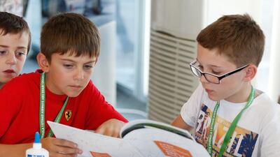 Children in the F1 in Schools tent in Main Oasis study the Junior Motorsport Book during the weekend's Formula One celebrations. Courtesy: Yas Marina Circuit