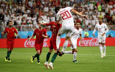 Sardar Azmoun of Iran heads the ball on to the arm of Portugal's Cedric, which resulted in a penalty. Getty