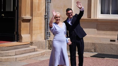 Mr Burnham and his wife Marie-France van Heel at Buckingham Palace. AFP