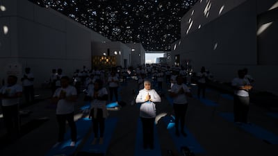 Participants gather under the dome of Louvre Abu Dhabi for a special International Day of Yoga celebration.