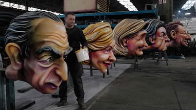 A man works on giant figures of (from L) presidential candidates Eric Zemmour, Valerie Pecresse, Marine Le Pen, Jean Luc Melanchon and Yannick Jadot as part of the preparation of floats for the upcoming 2022 Nice Carnival, on the french riviera city of Nice, on February 7, 2022. (Photo by Valery HACHE / AFP)