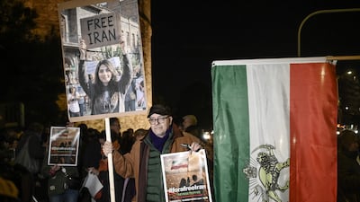 Demonstrators in Thessaloniki, Greece, hold placards and a pre-1979 revolution Iranian flag. AFP