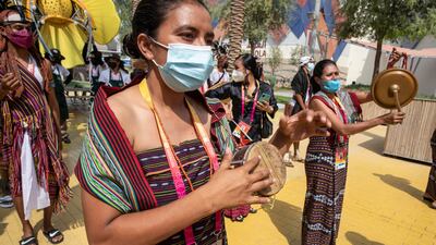 Performers from the Timor-Leste pavilion take part in a parade.