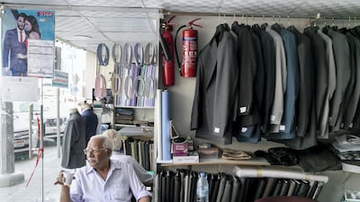 Mohammed Imtiaz sips tea at his shop Mohammed Rasheed Tailoring. Mr Imtiaz has lived in the UAE for almost 42 years. Reem Mohammed / The National