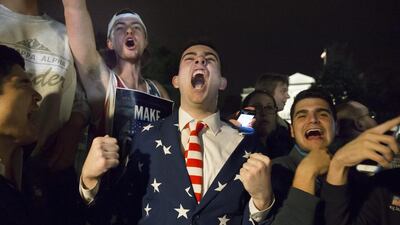 Supporters of US Republican presidential candidate Donald Trump cheer on Pennsylvania Avenue outside the White House, just before midnight at the end of election day. Michael Reynolds / EPA