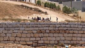 Israeli settlers gather in front of Palestinian houses in Qusra, south of Nablus. AFP