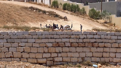 Israeli settlers gather in front of Palestinian houses in Qusra, south of Nablus. AFP