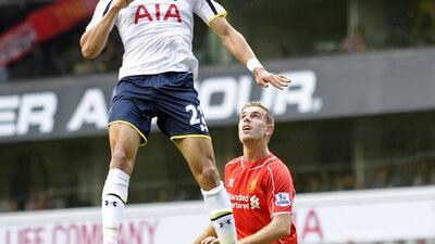 Tottenham Hotspur's Nacer Chadli vies for the ball with Liverpool's Jordan Henderson during their Premier League match on Sunday. Gerry Penny / EPA