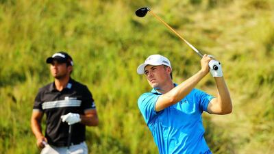 Jordan Spieth plays his tee shot for the 14th hole on Sunday during the final round of the US PGA Championship at Whistling Straits, winner Jason Day behind him looking on. Richard Heathcote / Getty Images / AFP / August 16, 2015