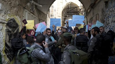 Israeli border police push back Muslim demonstrators near the entrance leading to where a small community of 350 Africans who came from Chad, Senegal, Sudan and Nigeria hundreds of years ago live in the Old City of Jerusalem on March 6, 2016. The entrance is also one of the main routes for Muslim worshippers going to the Al Aqsa Mosque which has been a flashpoint for violence since September 2015.