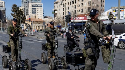 Israeli security troops ride electric vehicles through Machane Yehuda Market, in Jerusalem. Reuters
