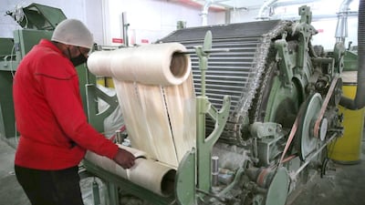 A Kashmir labourer works inside a silk factory on the outskirts of Srinagar. EPA
