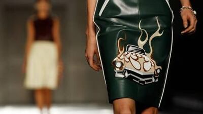 Prada adds a dose of bad-girl attitude to its 1950s-inspired pieces in its spring/summer 2012 women's collection at Milan Fashion Week.