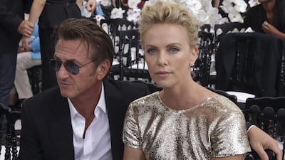Sean Penn and Charlize Theron pose prior to Dior's Haute Couture Fall/Winter 2014-2015 fashion show. Philippe Wojazer / Reuters