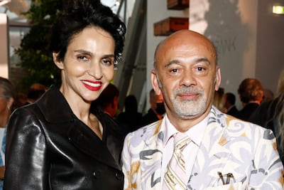 Farida Khelfa and Christian Louboutin at the Louis Vuitton Parfum Dinner in July in Paris. Getty Images